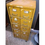 A yellow vintage metal multi drawer filing/storage cabinet on castors Please note, lots 1-1000 are