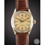 A GENTLEMAN'S 14K SOLID GOLD ROLEX OYSTER PERPETUAL WRIST WATCH CIRCA 1954, REF. 6584 WITH SILVER "