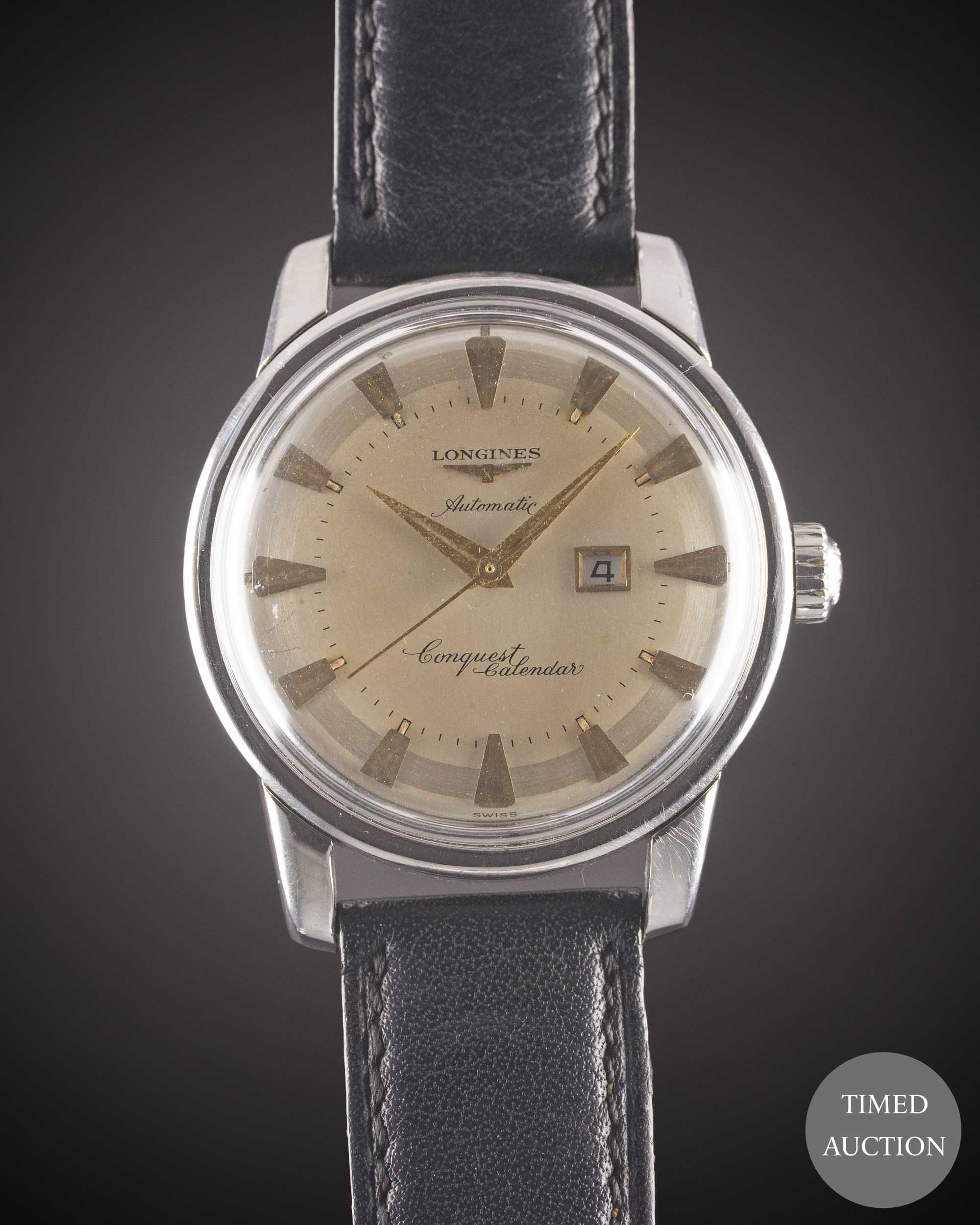 A GENTLEMAN'S STAINLESS STEEL LONGINES CONQUEST CALENDAR AUTOMATIC WRIST WATCH CIRCA 1957, REF. 9004