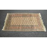 Beige ground rug having green and blue pattern with end tassels - 37.