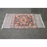 Blue ground rug having brown and cream decoration with end tassels - 30.