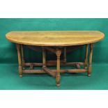 20th century oak gateleg dining table the top having bow ends and supported on block and turned