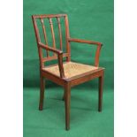Mahogany open elbow chair having moulded top rail supported by moulded uprights and vertical back