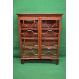 19th century mahogany glazed bookcase having moulded top over two glazed doors enclosing three