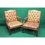 Pair of late 20th century Georgian style tanned leather buttoned open armchairs having padded arms