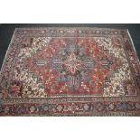 Red ground Persian Heriz rug having black,