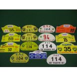 Fifteen aluminium and plastic motoring rally plaques for the front of a vehicle from 1960-2004