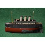 Bing tinplate model of a three funnel passenger ship in red,