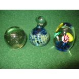 Mdina glass paperweight of blue and green colour together with a floral paperweight with bubble