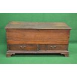 Oak mule chest the top lifting to reveal storage space over two short drawers with brass handles,