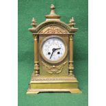 Brass mantle clock case having arched top with finials and circular porcelain dial having blue