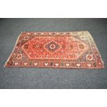 Red ground rug having red,