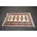 Cream ground rug having red,