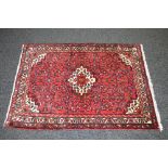 Red ground rug having pink, red,