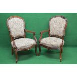 Pair of rosewood showwood frame open armchairs having shaped padded backs supported by sweeping