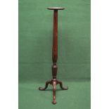Mahogany torchere having circular top with moulded edge supported on a reeded column leading three