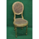 Gilt painted side chair having caned back with carved frame over shaped cane seat,