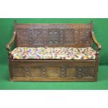 Oak carved box seat settle having carved panelled back bearing the inscription IM1667,
