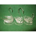 Set of three clear glass graduated swans in circular bases