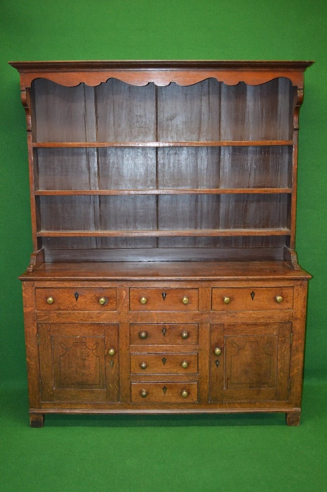 19th century oak dresser having canopy top over three plate shelves,