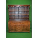 19th century oak dresser having canopy top over three plate shelves,