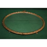 Oval gilt painted wall mirror with applied decoration and bevelled glass - 35.