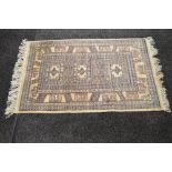 Beige ground rug having black and brown pattern with end tassels - 67" x 38.