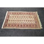 Beige ground rug having blue and red pattern with end tassels - 64" x 38"