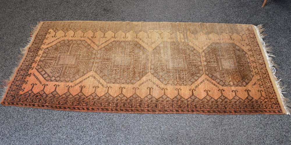 Light brown ground rug having dark brown pattern with end tassels - 85.