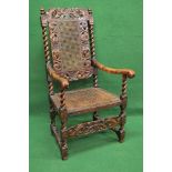 20th century carved and stained oak carver chair having cane back surmounted by carved decoration