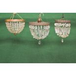 Group of three bag light chandeliers having cut glass drops