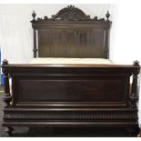 Victorian oak carved bed frame having panelled head and foot board flanked by reeded posts and