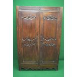 19th century oak French armoire having two doors with shaped fielded panels over a shaped frieze,