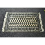 Cream ground rug having blue and green pattern with end tassels - 62" x 32.