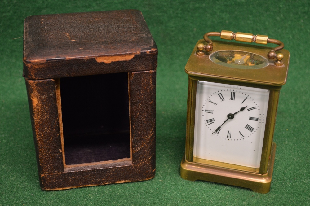 Un-named brass cased carriage clock having top swing handle and white enamel dial with black Roman