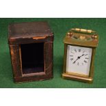 Un-named brass cased carriage clock having top swing handle and white enamel dial with black Roman