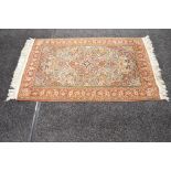 Cream ground rug having intricate pattern of red, pink, blue and green with end tassels - 65" x 37.