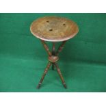 Circular Gypsy table the top having carved central decoration and a moulded edge supported on three