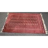 Red ground rug having blue and cream pattern and end tassels - 77" x 51"