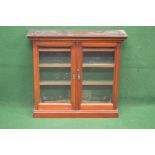 Small mahogany glazed floor standing cabinet having moulded cornice over two glazed doors opening