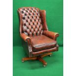20th century Georgian style red leather swivel button back wing armchair having removable seat