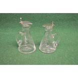Two silver mounted glass whisky tots of conical form with glass handles and star cut bases