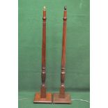 Pair of mahogany standard lamps having reeded columns leading to square bases with chamfered edges,