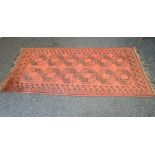 Red ground rug having black pattern and end tassels - 84.5" x 42.