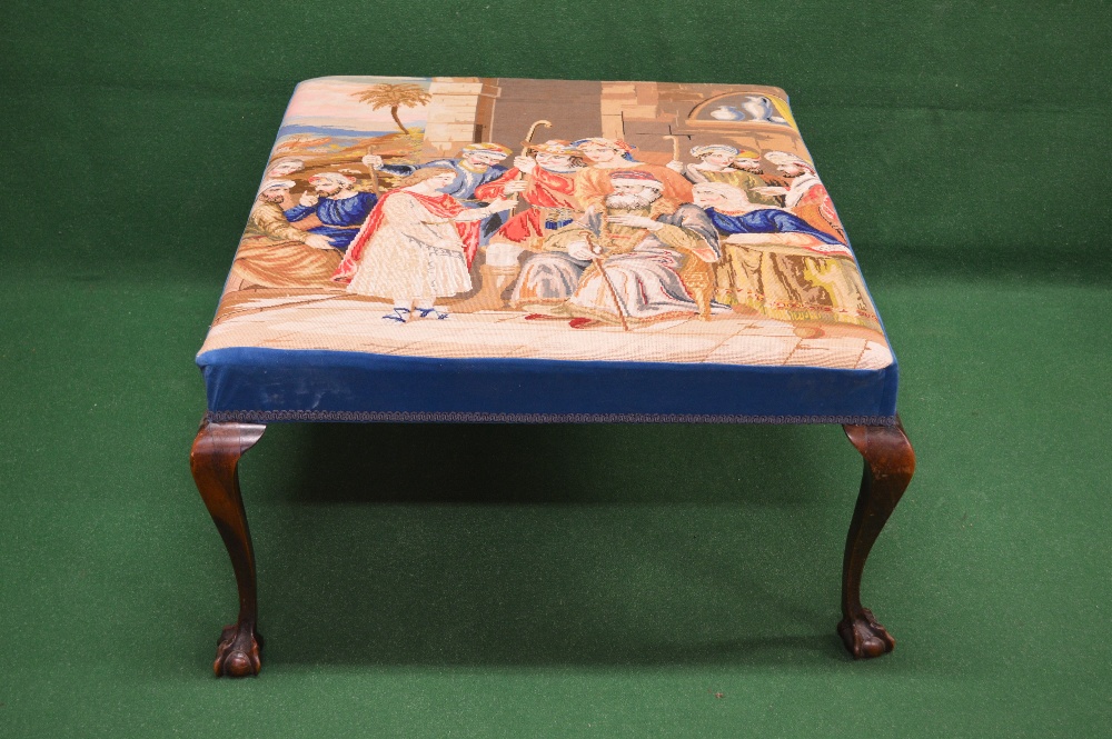 Large foot stool having padded top with tapestry upholstery of a scene of figures gathered around