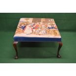 Large foot stool having padded top with tapestry upholstery of a scene of figures gathered around