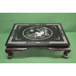 20th century black lacquered coffee table having Mother of Pearl inlay decoration of central panel