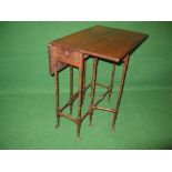 Mahogany spider leg drop leaf table having rectangular top with two drop leaves over single small