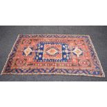 Red and blue ground rug having brown, red and blue pattern - 79" x 50.