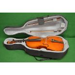 Unnamed cello with two bows contained in a travel light case